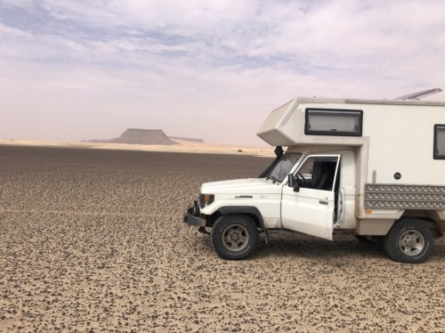 El goullouaya - magical play of dunes, mountain escarpments, dried up lake, monolithic black rocked island, dromeda bones &amp; a rose coloured haze,